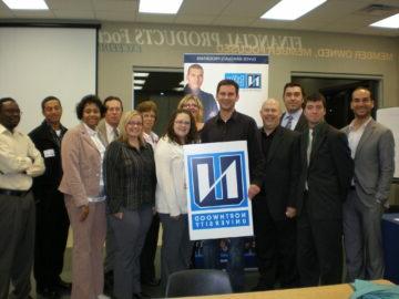 A group of Northwood University alum from the Lansing chapter posing for a photo